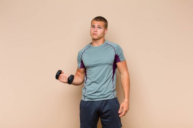 Genç sarışın adam üzgün ve mızmız, mutsuz bir bakışla, negatif ve hayal kırıklığına uğramış bir tavırla ağlıyor.