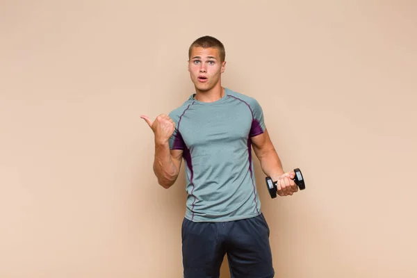 Young Blonde Man Looking Astonished Disbelief Pointing Object Side Saying — Stock Photo, Image