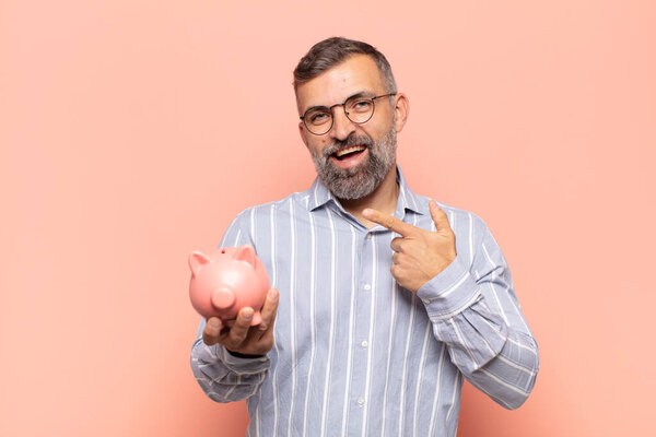 adult handsome man looking excited and surprised pointing to the side and upwards to copy space