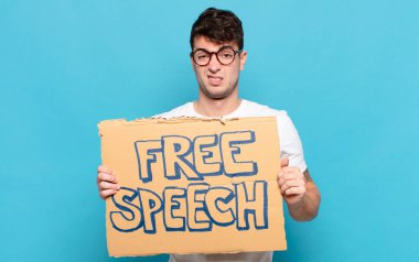 young man feeling puzzled and confused, with a dumb, stunned expression looking at something unexpected