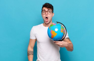 Genç adam şok olmuş ya da şaşırmış görünüyor, ağzı açık bir şekilde 