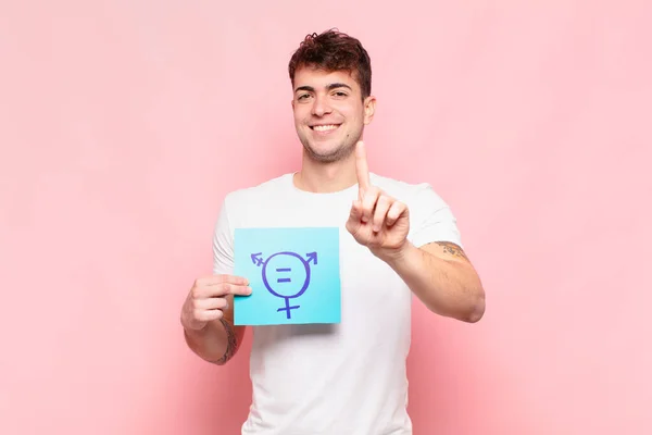 Young Man Smiling Proudly Confidently Making Number One Pose Triumphantly — Stock Photo, Image