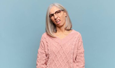 middle age woman feeling puzzled and confused, with a dumb, stunned expression looking at something unexpected