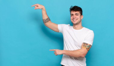 Mavi arka planda genç yakışıklı adam