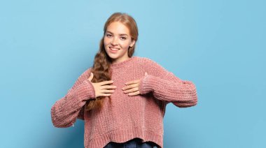 Sarışın, güzel bir kadın mutlu, şaşırmış, gururlu ve heyecanlı görünüyor.