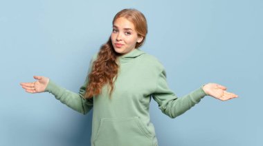 blonde pretty woman feeling clueless and confused, having no idea, absolutely puzzled with a dumb or foolish look