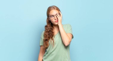 Yorucu, sıkıcı ve sıkıcı bir görevin ardından sıkılmış, hayal kırıklığına uğramış ve uykulu hisseden sarışın güzel bir kadın.