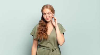 sarışın güzel bir kadın stresli, hayal kırıklığına uğramış ve yorgun, endişeli ve sorunlu bir bakışla boynunu ovalıyor.