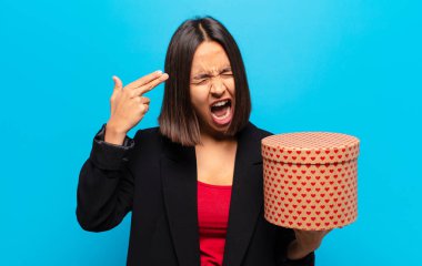 Genç ve güzel bir kadın elinde bir hediye kutusu tutuyor.