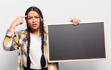 İspanyol kadın şaşkın ve şaşkın hissediyor. Deli, deli ya da aklını kaçırmış olduğunu gösteriyor.