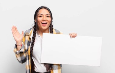 İspanyol kadın kendini mutlu, şaşırmış ve neşeli hissediyor. Pozitif bir tavırla gülümsüyor. Bir çözüm ya da fikir buluyor.