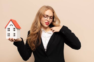 sarışın kadın stresli, endişeli, yorgun ve hayal kırıklığına uğramış, gömleğini çekiştiren, sıkıntılı görünen