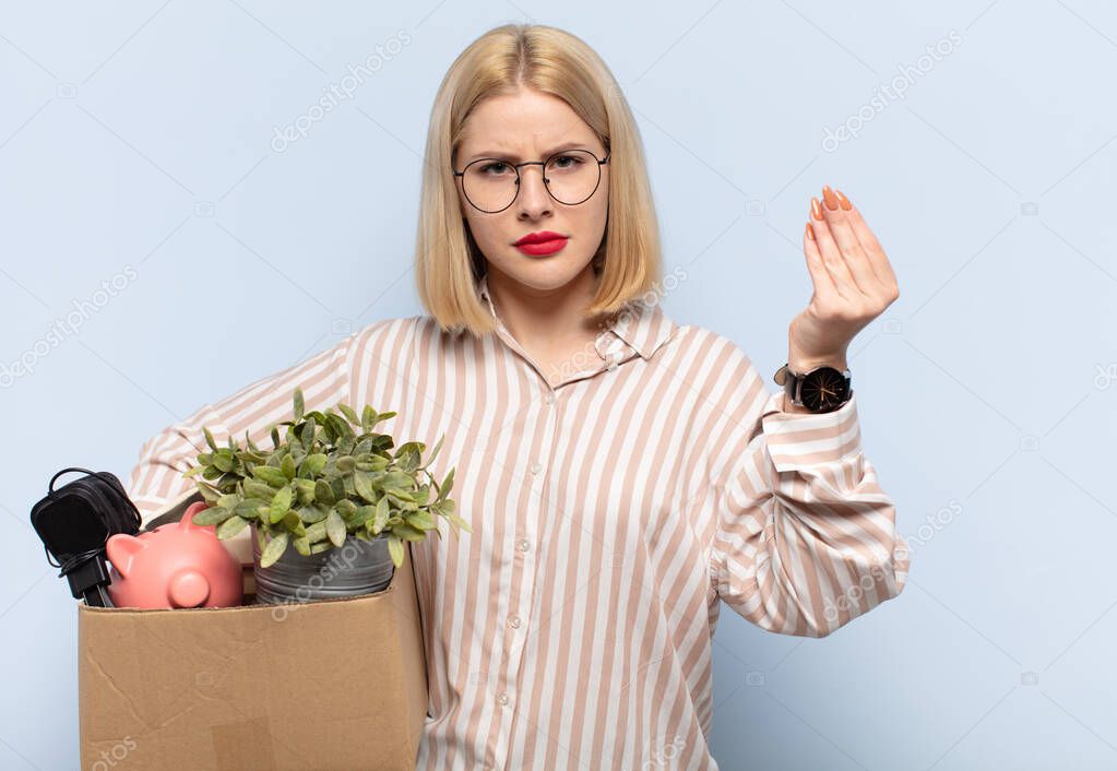 blonde woman making capice or money gesture, telling you to pay your debts!