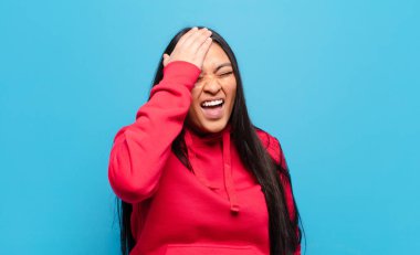 Latin kadın gülüyor ve alnına şaplak atıyor. Unuttum ya da aptalca bir hataydı. 