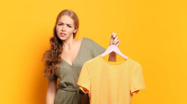 feeling puzzled and confused, with a dumb, stunned expression looking at something unexpected