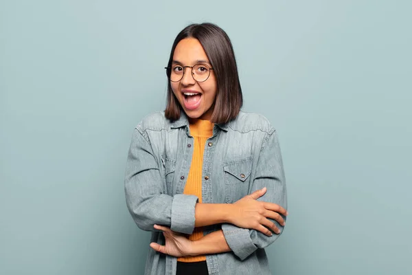 stock image young hispanic woman looking happy and pleasantly surprised, excited with a fascinated and shocked expression