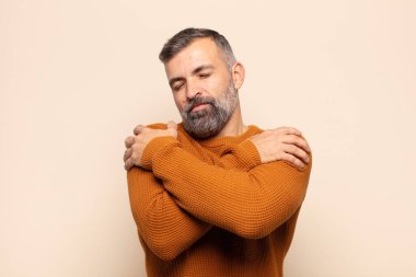 Yetişkin, yakışıklı, aşık, gülümseyen, kendine sarılan, bekar, bencil ve bencil bir adam.