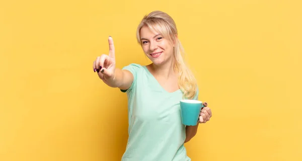 Blonde Woman Smiling Proudly Confidently Making Number One Pose Triumphantly — Stock Photo, Image