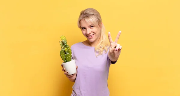 Blonde Woman Smiling Looking Happy Carefree Positive Gesturing Victory Peace — Stock Photo, Image
