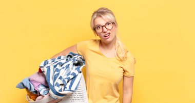 blonde woman feeling puzzled and confused, with a dumb, stunned expression looking at something unexpected