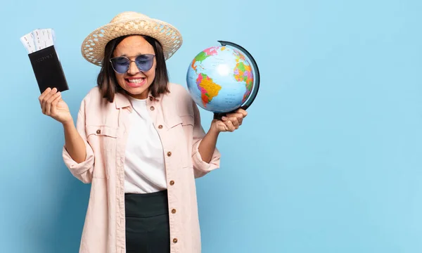 young pretty traveler woman with a world globe map. travel or holidays concept