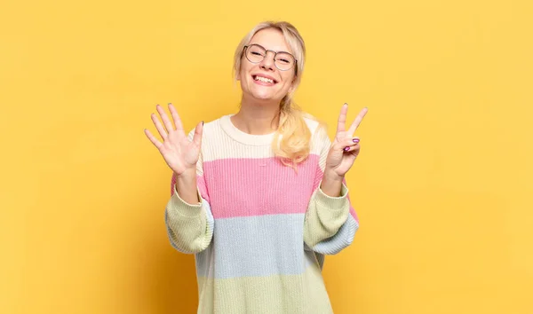 Blondine Lächelt Und Sieht Freundlich Aus Zeigt Nummer Sieben Oder — Stockfoto