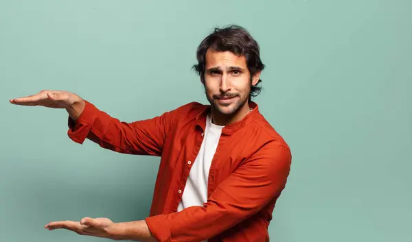 Young Handsome Indian Man Holding Object Both Hands Side Copy — Stock Photo, Image