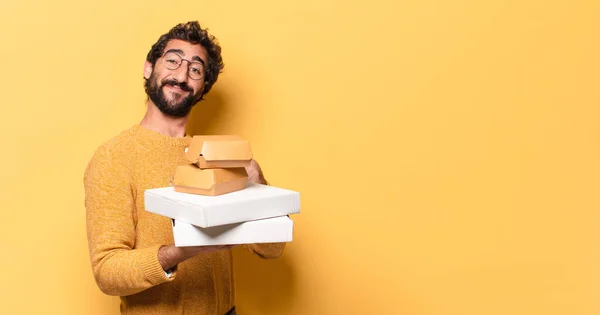 young crazy bearded man having take away fast food with a copy space