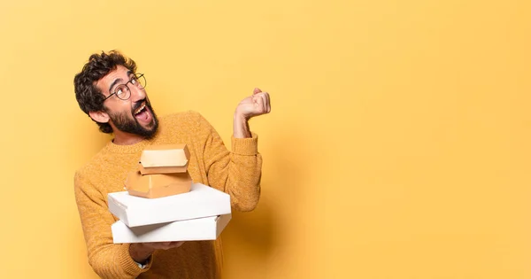 young crazy bearded man having take away fast food with a copy space