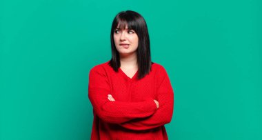 Artı cüsseli, kuşkulanan, düşünen, dudağını ısıran, kendine güveni olmayan ve gergin bir kadın.