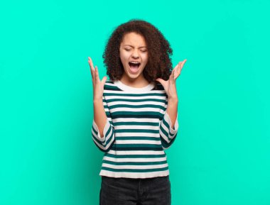 Kız öfkeyle bağırıyor, stresli hissediyor ve ellerini havaya kaldırıp neden ben diye bağırıyor.