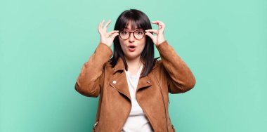 Ayrıca boyunda güzel bir kadın şaşkın, şaşkın ve şaşırmış, elinde şaşkın, inançsız bir bakışla gözlük tutuyor.