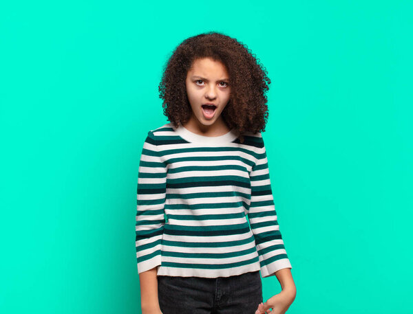 Girl looking shocked, angry, annoyed or disappointed, open mouthed and furious