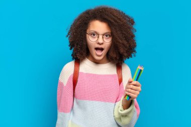 Oldukça afro bir genç şok olmuş ya da şaşırmış görünüyor, ağzı açık bir şekilde 