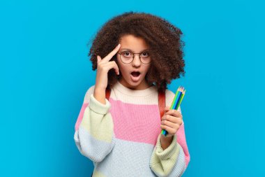 Şaşırmış, ağzı açık, şok olmuş, yeni bir düşünce, fikir ya da konsept keşfeden afro bir genç. öğrenci konsepti