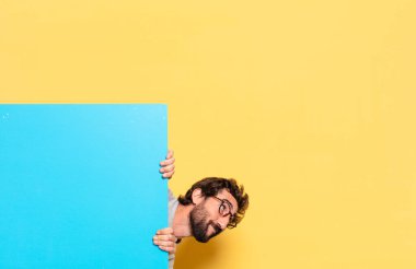 Genç, çılgın, sakallı bir adam duygularını fotokopi aletiyle ifade ediyor.