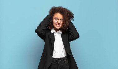 Oldukça afro bir genç stresli, endişeli, endişeli ya da korkmuş, elleri başının üstünde, hatayla panikliyor. mizahi iş konsepti
