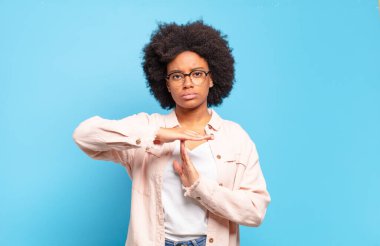  Ciddi görünüyor, sert, kızgın ve hoşnutsuz, mola işareti yapıyor.