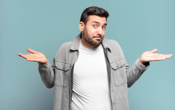 handsome adult blond man feeling puzzled and confused, doubting, weighting or choosing different options with funny expression