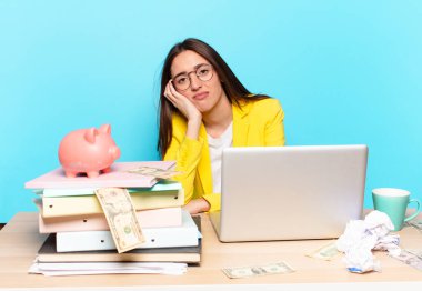 Masasında oturmuş dizüstü bilgisayarla çalışan güzel bir iş kadını.