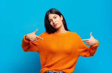 Genç, güzel İspanyol bir kadın gururlu, kibirli, mutlu, şaşırmış ve tatmin olmuş görünüyor, kendini gösteriyor, kendini kazanan gibi hissediyor.