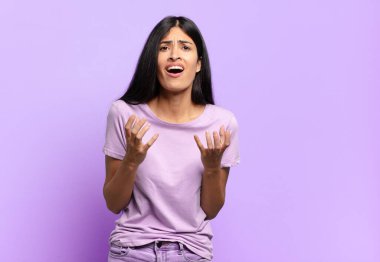 Genç ve güzel İspanyol bir kadın umutsuz ve hayal kırıklığına uğramış görünüyor, stresli, mutsuz ve sinirli, bağırıyor ve çığlık atıyor.