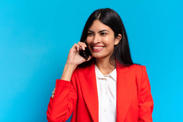 young hispanic businesswoman using her telephone