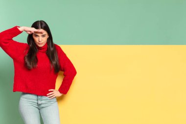 young pretty woman looking bewildered and astonished, with hand over forehead looking far away, watching or searching. copy space to place your concept