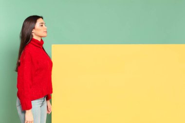 young pretty woman on profile view looking to copy space ahead, thinking, imagining or daydreaming. copy space to place your concept