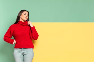 young pretty woman looking arrogant, successful, positive and proud, pointing to self. copy space to place your concept