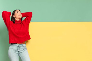 young pretty woman smiling and feeling relaxed, satisfied and carefree, laughing positively and chilling. copy space to place your concept