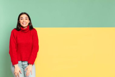 young pretty woman looking happy and goofy with a broad, fun, loony smile and eyes wide open. copy space to place your concept