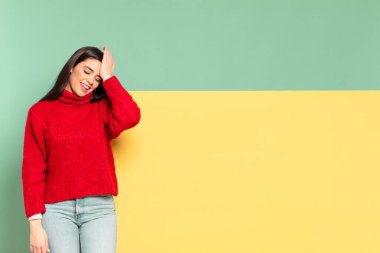 young pretty woman laughing and slapping forehead like saying doh! I forgot or that was a stupid mistake. copy space to place your concept 