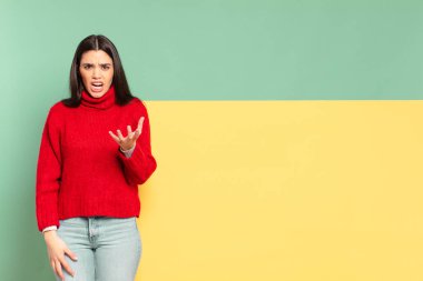 young pretty woman looking angry, annoyed and frustrated screaming wtf or whats wrong with you. copy space to place your concept 